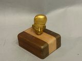 a small wooden box with a gold figurine on it