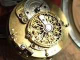 a close up of a pocket watch on a table