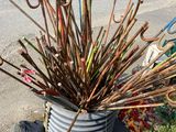 a bucket full of sticks sitting on the side of the road