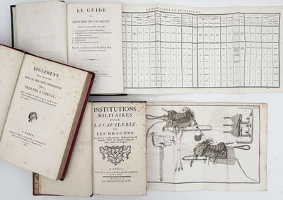 several old books sitting on top of each other on a table