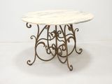 wrought iron table with a marble top on a white background