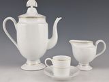 a white tea pot and two cups on a table
