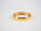 a close up of a gold ring on a white surface