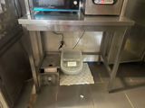a microwave and a toaster on a stand in a kitchen