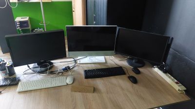 un bureau sur lequel sont posés deux écrans d'ordinateur et un clavier