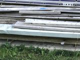 a pile of wood on the ground outside of a building