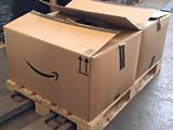 a box on a pallet with a smile drawn on it