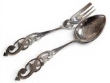 two spoons and a fork on a white surface