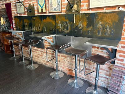 three stools that are sitting in front of a brick wall