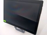 a tablet computer sitting on a stand on a white surface