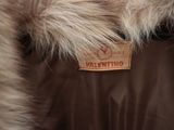 a close up of a fur coat with a tag on it