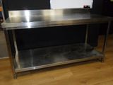 a stainless steel table with a shelf underneath it