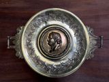 a silver plate with a picture of a man on it