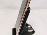 a close up of a cell phone in a holder on a table