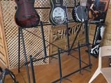 many guitars on display in a room with wood floors