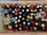 many bottles of beer in a cardboard box on the floor