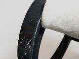 a close up of a black ring on a white surface