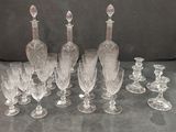 a lot of wine glasses and a decanter on the table