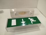 a green sign with a white arrow pointing to the left
