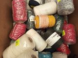 many balls of yarn in a box on the floor
