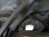 a close up of a black jacket with a label on it