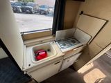 a small kitchen with a sink and a refrigerator inside of it