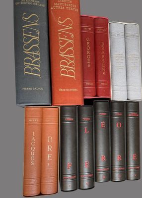 several books are stacked on top of each other on a shelf