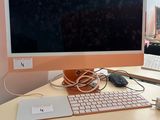 a computer monitor sitting on a desk next to a keyboard and mouse