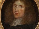 portrait of a man in a black coat and white collared shirt