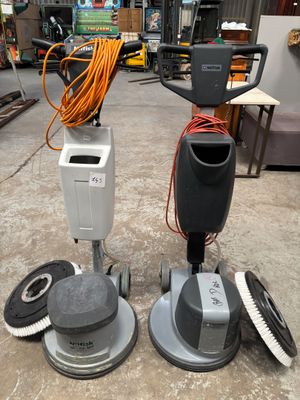 two machines that are sitting on the floor in the garage