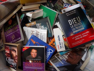 a pile of books sitting on top of a pile of books