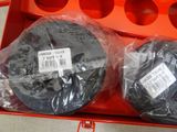 two black discs in a red box on the table