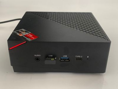 a close up of a small black device on a white surface