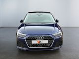 the front of a blue audi car in a white room