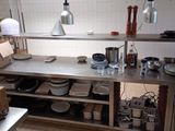 many plates and bowls on the counter in the kitchen