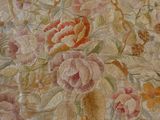 a close up of a painting of flowers on a bed