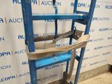 an image of a blue ladder with a piece of wood on top of it