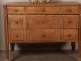 a dresser with a mirror on top of it in a room