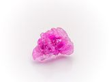 a close up of a pink ring on a white surface