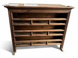 a wooden shelf with many drawers on it