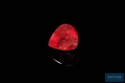 a red diamond on a black surface in the dark