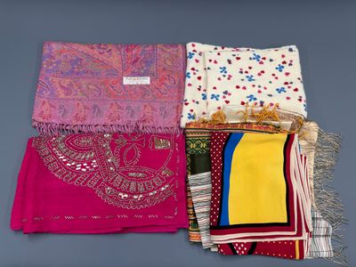 un ensemble de quatre foulards de couleurs différentes posés sur une surface grise
