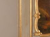 a fireplace with a painting on the front and a mirror on the back of it