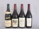 four bottles of wine are lined up on a table