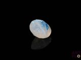 an image of a white and blue stone on a black surface