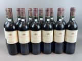 six bottles of wine are lined up in a row on a table