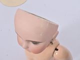 a small doll with a hat on it ' s head