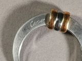 a silver ring with two gold rings on it