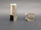 a silver object that is sitting next to a cup
