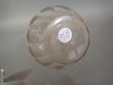 a glass jar with a sticker on it sitting on a table